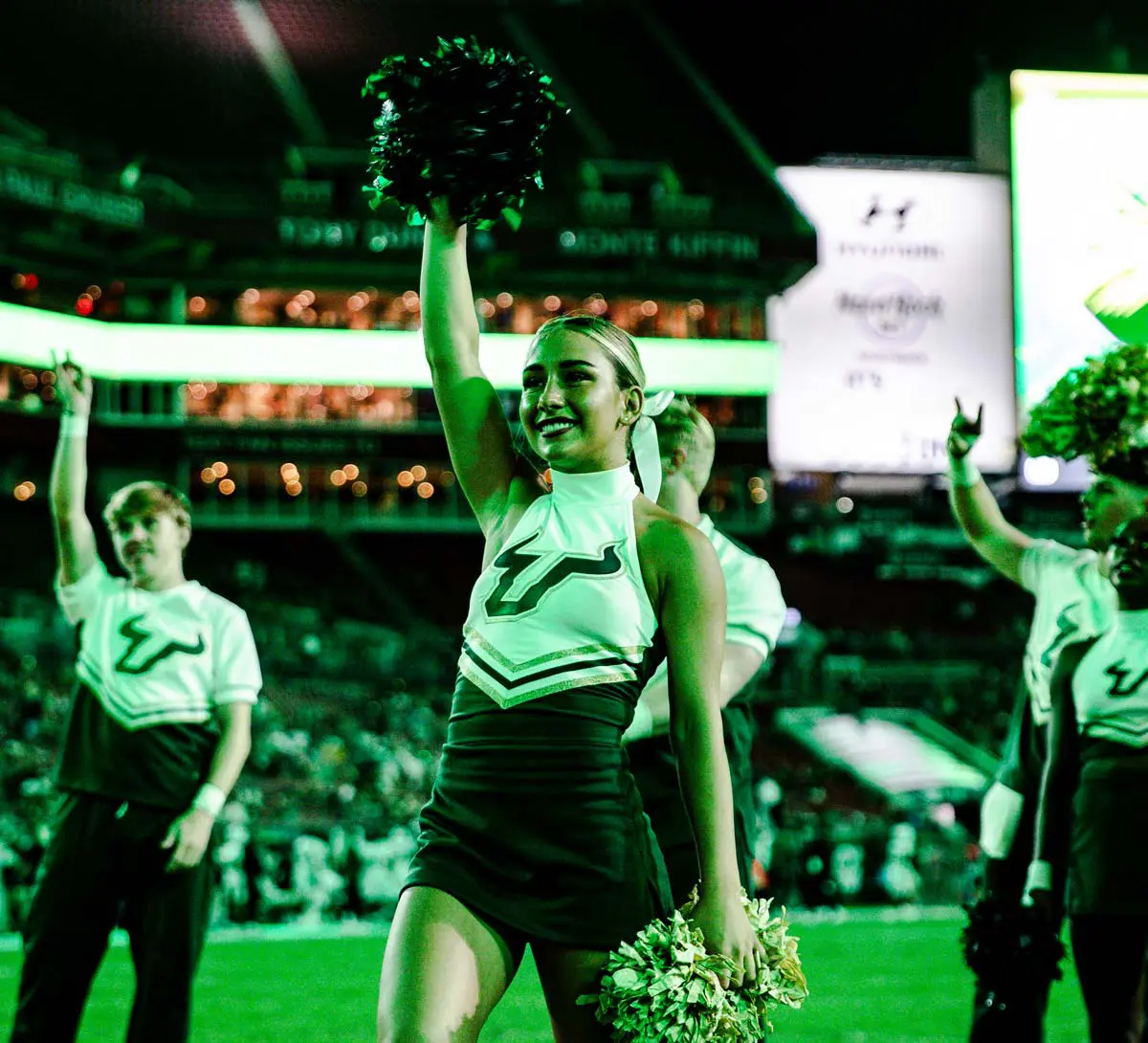 Cheerleader raising a pom pom